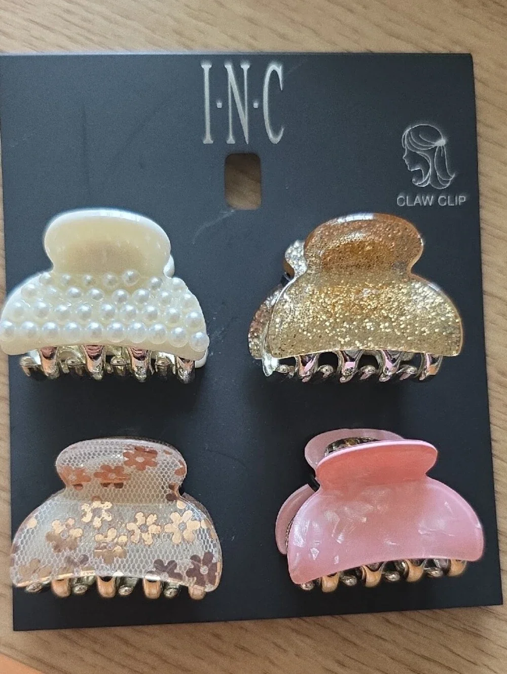 I.N.C. hair accessory set includes four distinct small acrylic claw clips.